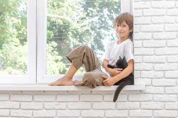 indoor portrait of young happy smiing child boy with little blac