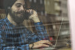 © lukafunduck - Young hipster man working on laptop in coffee shop