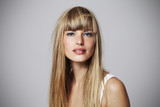 Alluring young blond woman in studio