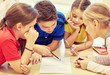 © Syda Productions - group of students talking and writing at school