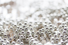Close Up Of Silver Beads On Shiny Sequined Texture