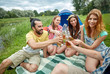 © Syda Productions - happy friends with tent and drinks at campsite