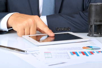 Close-up Of Businessman Analyzing Graph On Digital Tablet