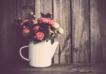 Bouquet of roses in vintage coffee pot