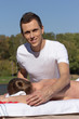 © PaulShlykov - Man giving massage to young brunette outdoors