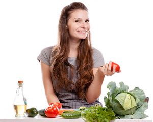 Young Woman Cooking in the kitchen. Healthy Food - Vegetable Salad. Diet. Dieting Concept. Healthy Lifestyle. Cooking At Home.