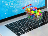 Fototapeta Tęcza - shopping cart with application software icons on laptop