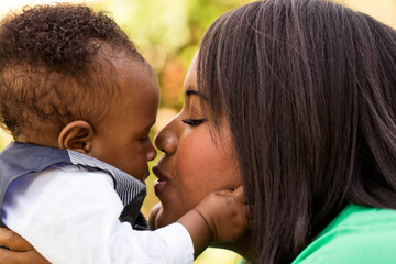african american mother holding her son.