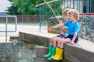 Wall Mural - Two adorable little friends  fishing with selfmade rod