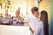 © olly - In love teenagers doing a selfie while kissing
