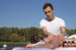 © PaulShlykov - Man giving massage to young brunette outdoors
