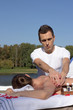 © PaulShlykov - Man giving massage to young brunette outdoors