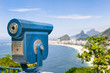 Scenic overlook view of Copacabana Beach in Rio de Janeiro, Brazil with a telescope [English translation of sign: Telescope for viewing of landscape]