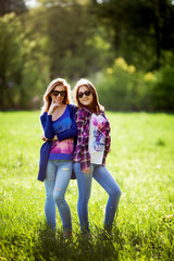 Two happy pretty young sisters.Outdoors.