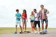 © Syda Productions - happy teenage friends with longboards outdoors