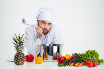 Poster - Male chef cook with vegetables on the table