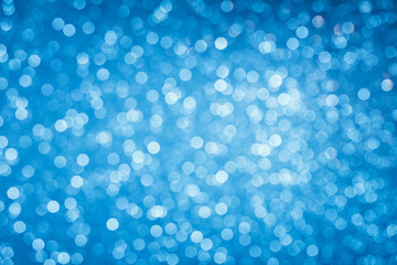 Wall Mural - Glowing blue bokeh lights background