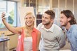 © WavebreakmediaMicro - Businesswoman taking selfie with male colleagues
