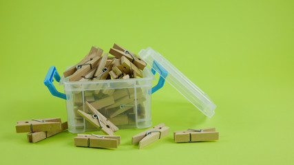 Wood clothespins in mini plastic box container. (2)