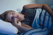 sleep disorder, insomnia. young blonde woman lying on the bed aw