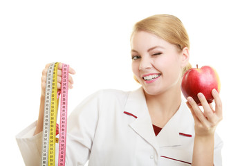 Doctor specialist holding fruit apple and measure tape