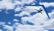 Hang Glider flying in Kitty Hawk North Carolina on a clear, bright, blue sunny day with clouds in the sky