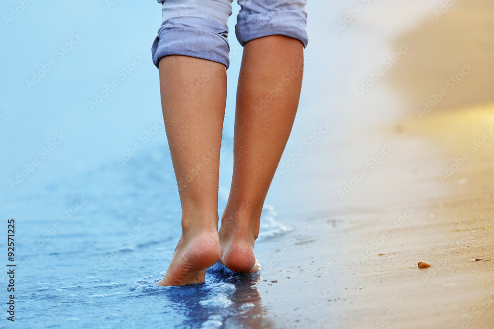Woman walking on sand beach