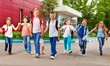 © Sergey Novikov - Row of happy kids with bags near school building