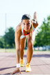© NDABCREATIVITY - Female sprinter getting ready for the run