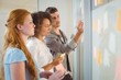 © WavebreakMediaMicro - Businessman writing on glass as female colleagues looking at it