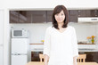 © taka - young asian woman relaxing in the kitchen