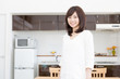 © taka - young asian woman relaxing in the kitchen
