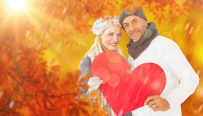 Wall Mural - Composite image of portrait of happy couple holding heart