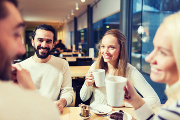 Canvas Print - happy friends meeting and drinking tea or coffee