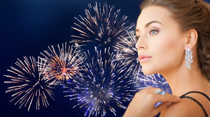 Wall Mural - beautiful woman with diamond earring over firework