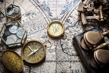 Fototapete - Old compass, astrolabe on vintage map. Retro style.