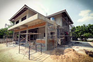 building residential construction house with scaffold steel