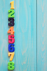 Wall Mural - Set of plastic numbers on wooden background