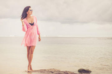 portrait of a beautiful brunette girl on the beach