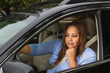 © pixelheadphoto - Woman sitting in her car daydreaming.