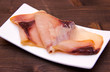 Smoked swordfish on small tray on wooden table