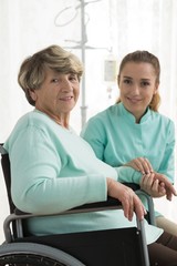 Canvas Print - Smiling disabled woman and nurse