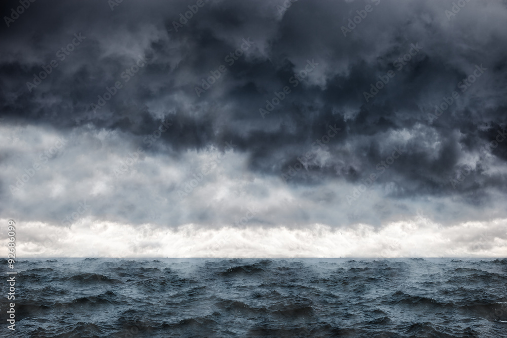 Dark clouds in the winter sky during a storm at sea. - obrazy, fototapety, plakaty 