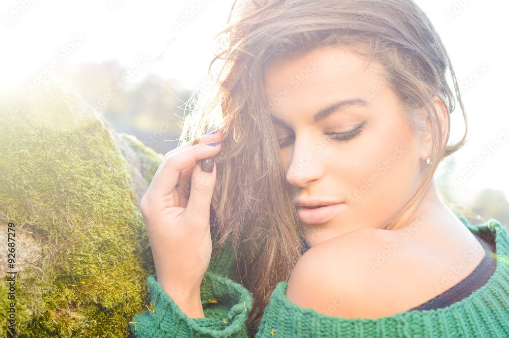 Girl in green sweater with naked shoulder with lens flare Stock Photo ...