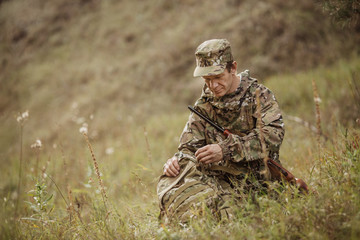 Wall Mural - hunter in camouflage clothes ready to hunt with hunting rifle