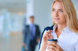 © lenets_tan - Yound woman drink coffee at office, standing