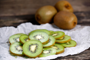 Fresh Green healthy Kiwi Fruits Full and Sliced on Wooden Table Background. rich with vitamin.