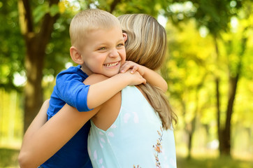 Little son hugging his mother