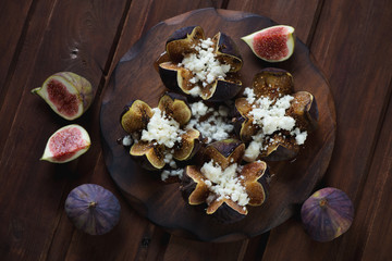 Poster - Baked figs with cottage cheese and honey, dark wooden surface