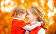 happy family. mother and child little daughter play kissing on a